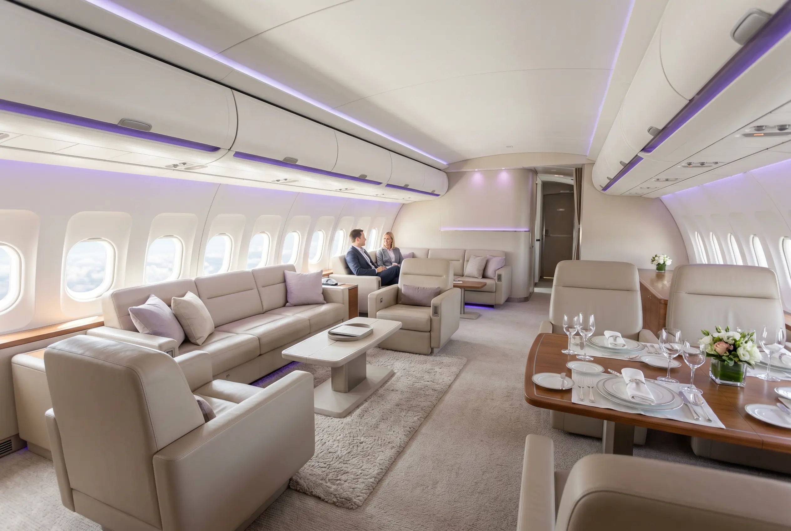 Airbus ACJ319 VIP lounge with sofas and a dining area for a Miami to New York charter