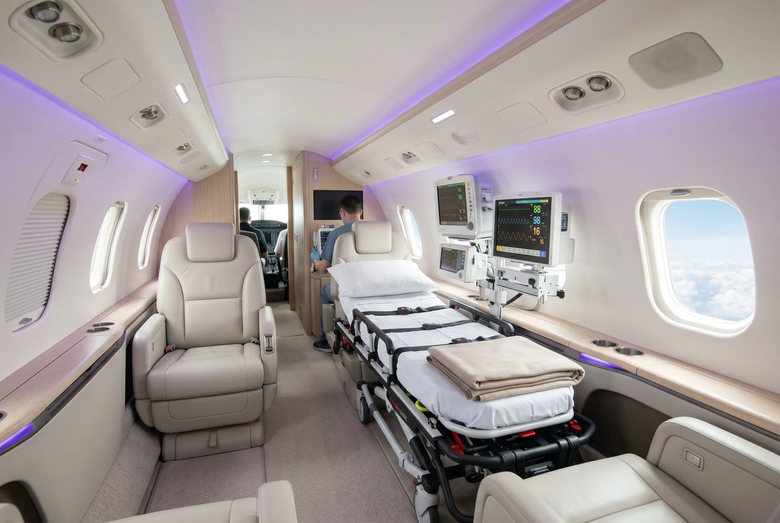 Medically equipped jet cabin with a stretcher and monitors for a Miami to New York transfer