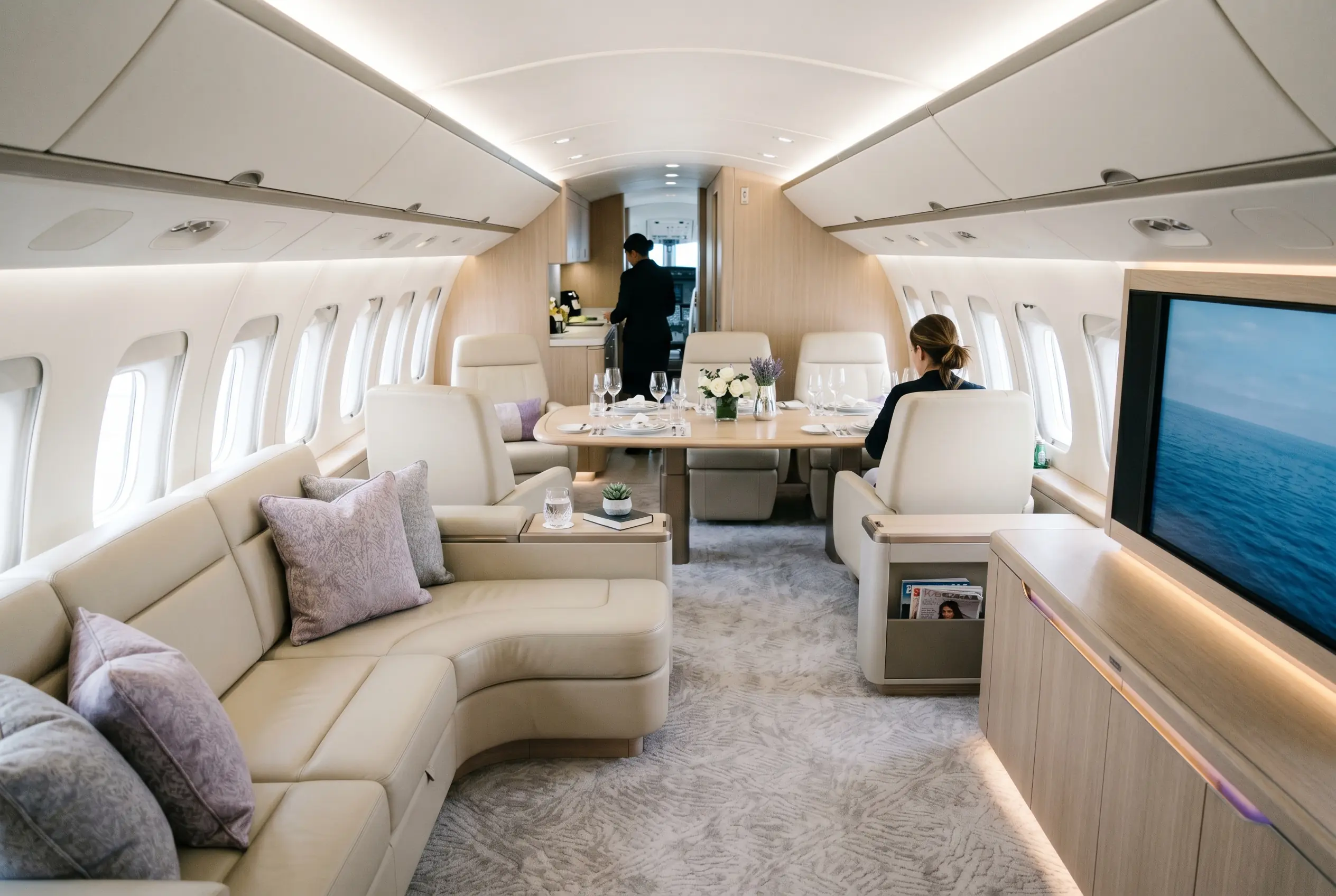 Boeing BBJ MAX 8 VIP lounge with sofas and a dining area for a Miami to New York charter