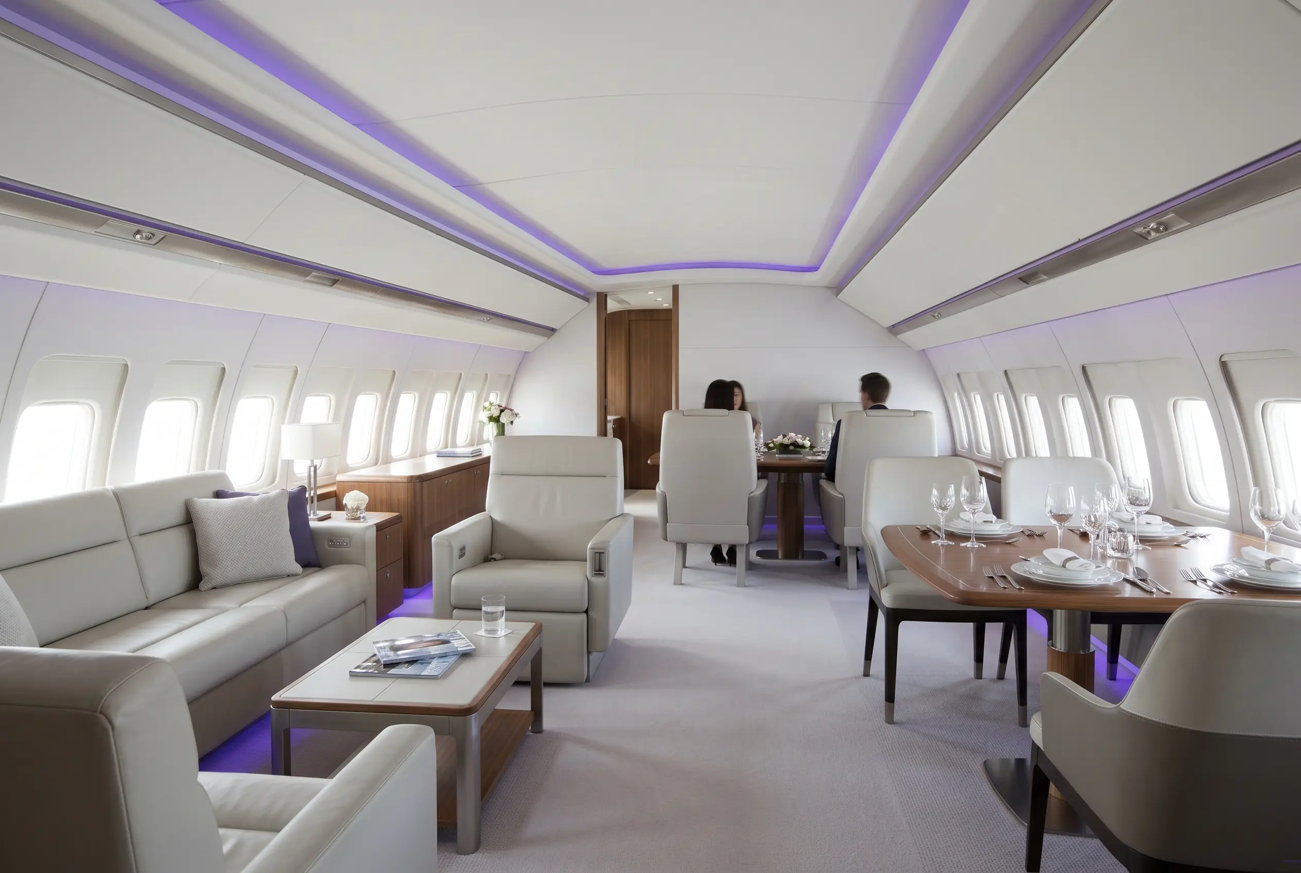 Boeing BBJ VIP lounge with sofas and a dining area for a Miami to New York charter