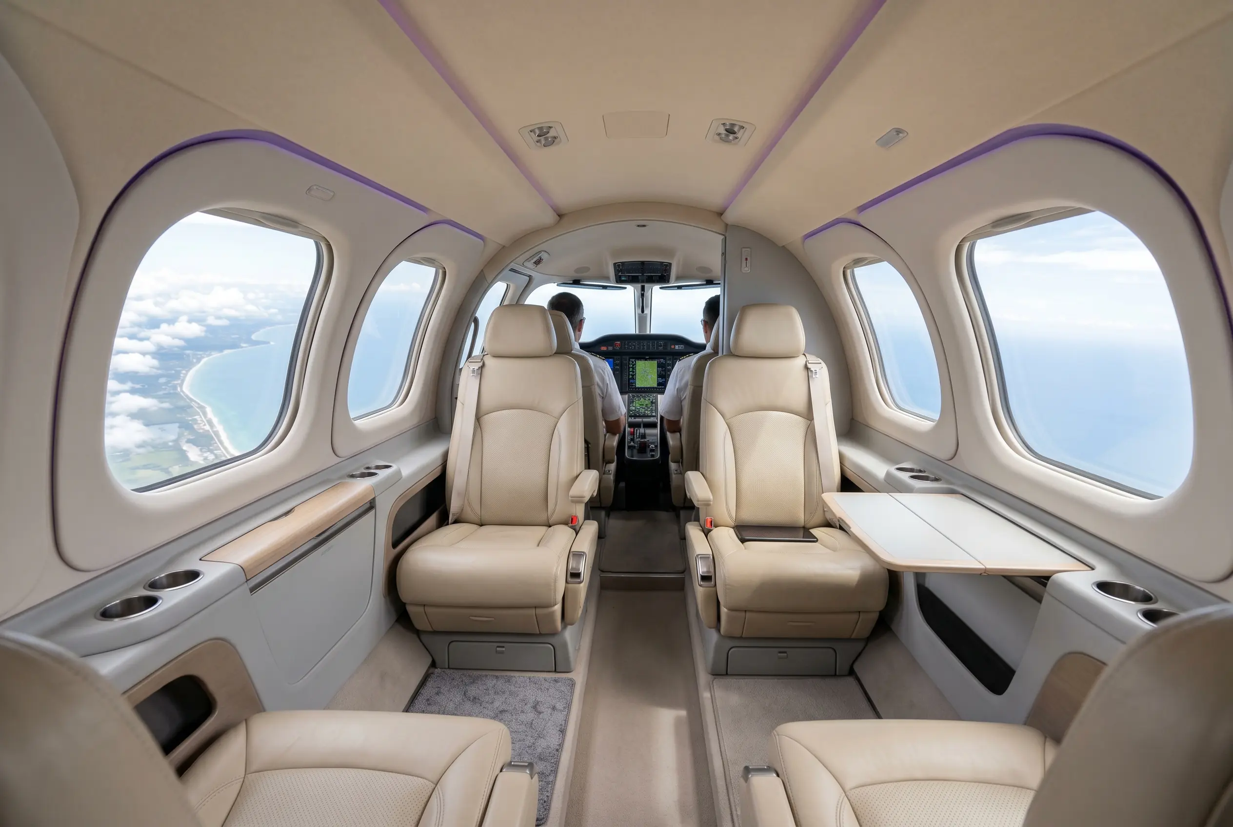 Cirrus Vision Jet G2+ cabin with panoramic windows set for a Miami to New York charter