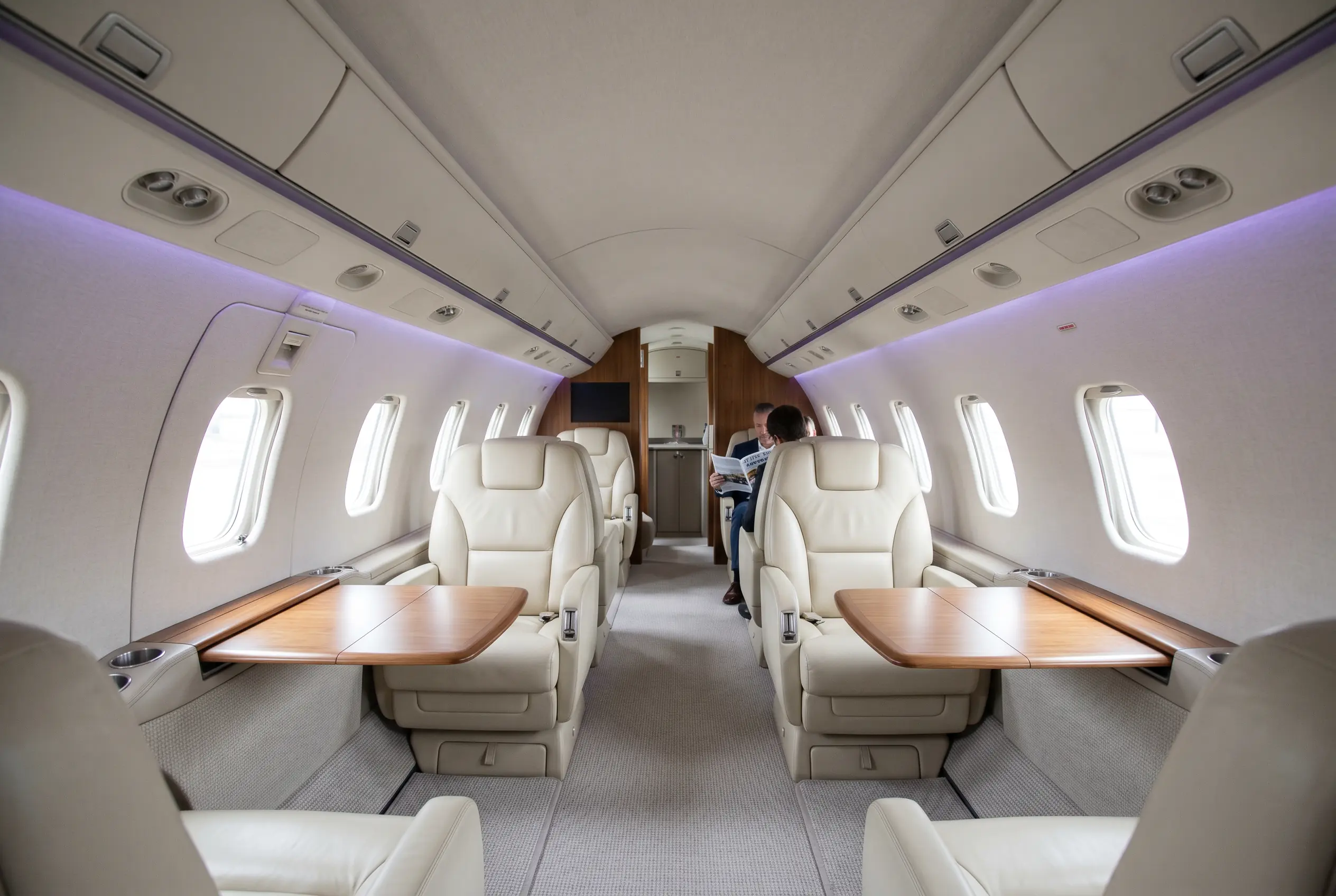 Hawker 900XP wide stand-up cabin with club seating for a Miami to New York charter