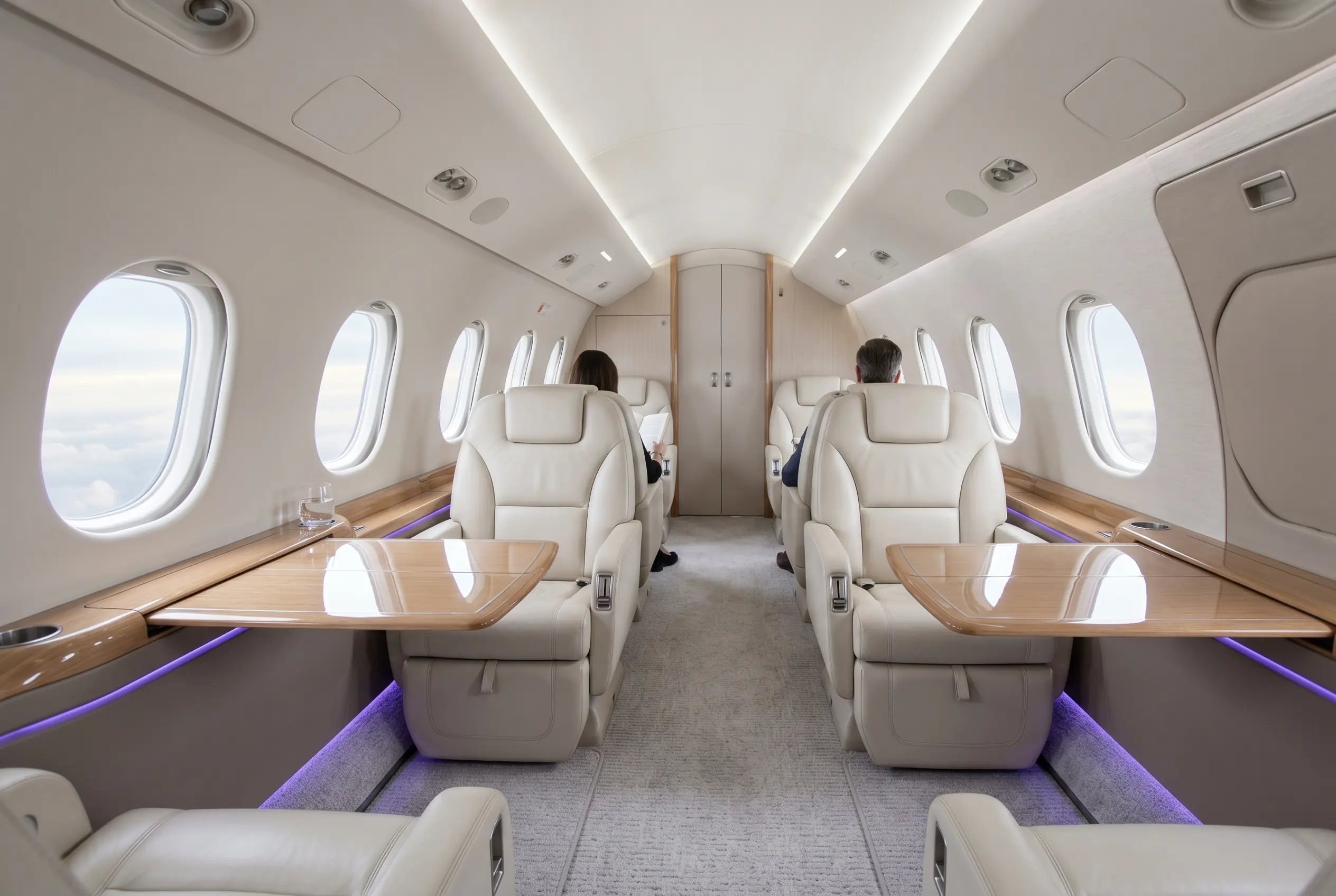 Midsize jet cabin with full standing height and club seating for a Miami to New York charter