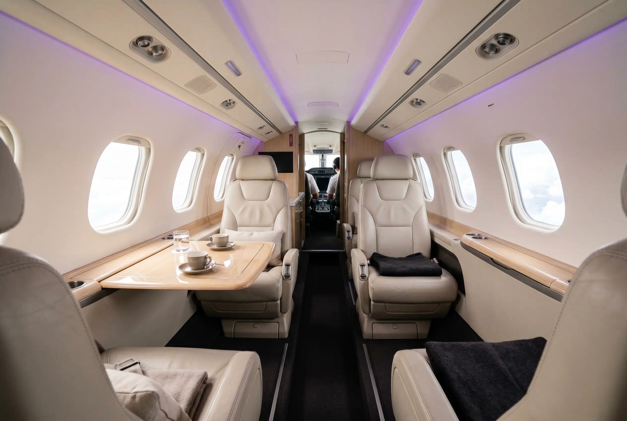 Embraer Phenom 100EV cabin with club seating set for a Miami to New York charter