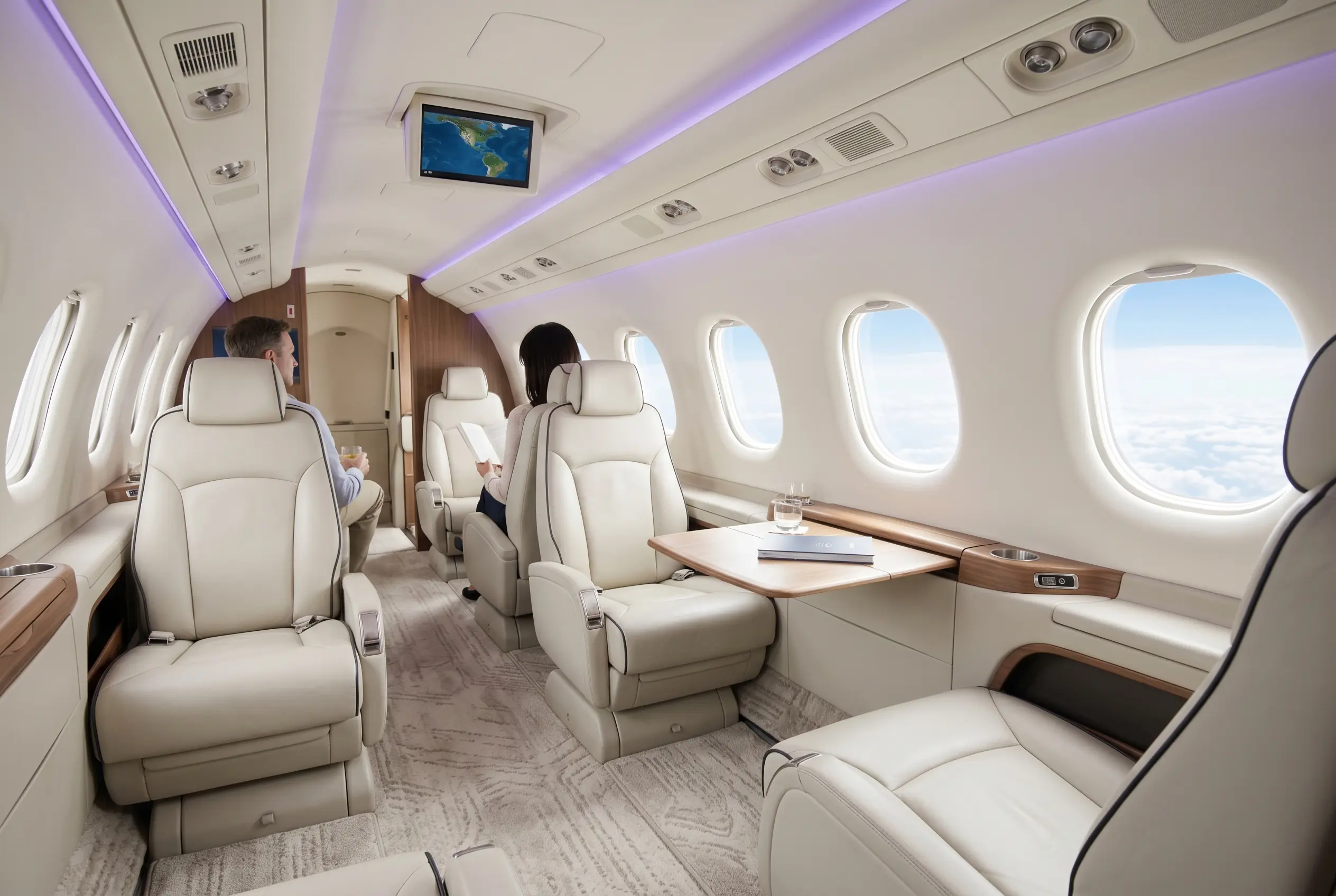 Embraer Phenom 300E cabin with club seating and large oval windows for a Miami to New York charter
