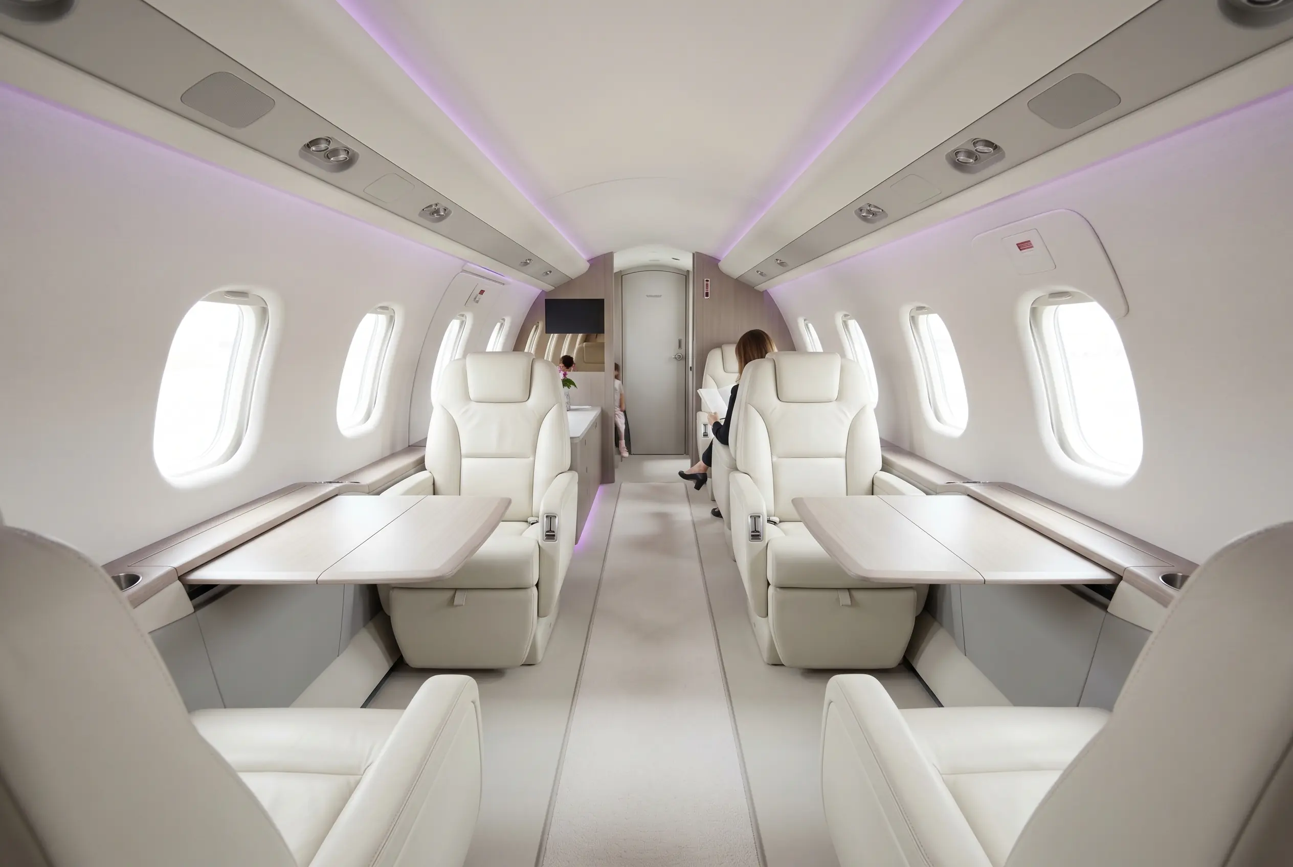 Pilatus PC-24 cabin with a flat floor and club seating for a Miami to New York charter