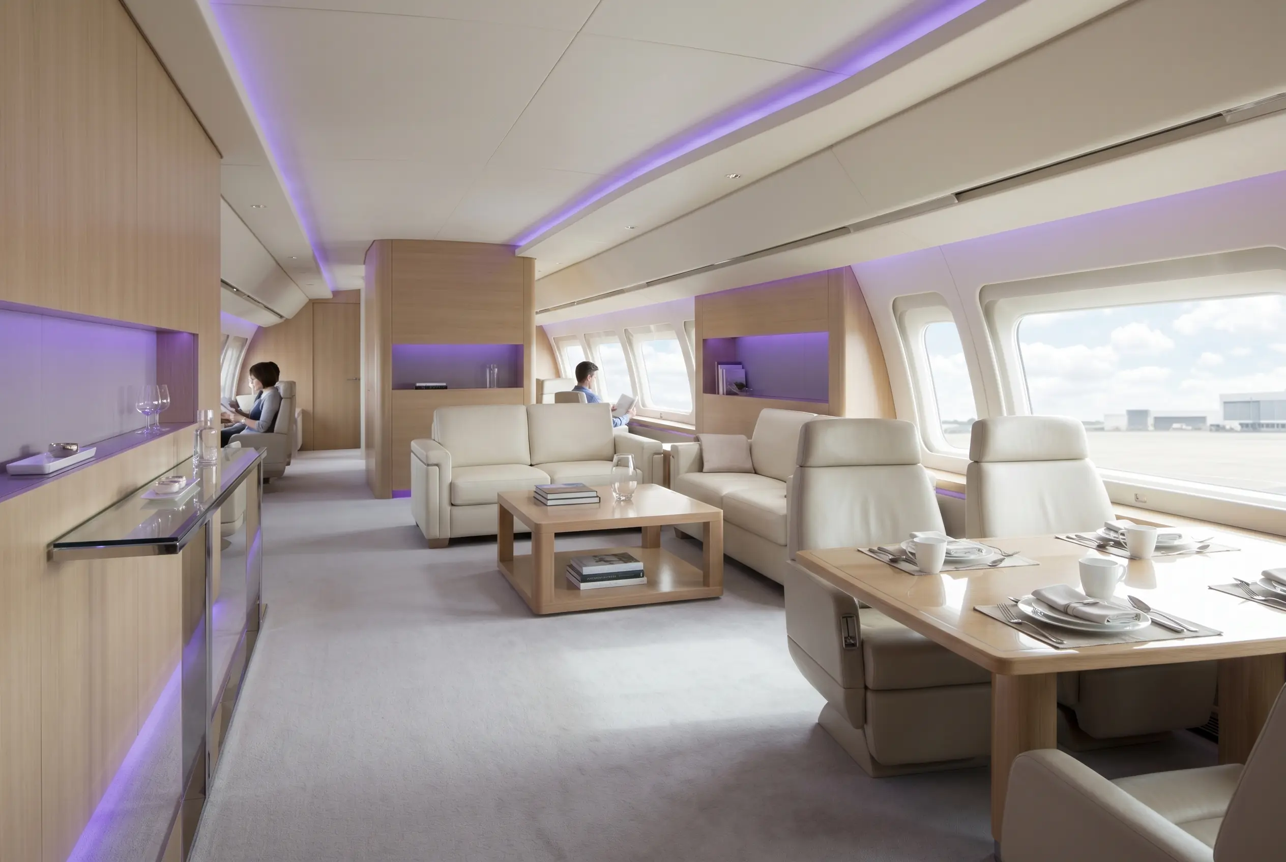 Spacious VIP airliner lounge with sofas and a dining table for a Miami to New York charter